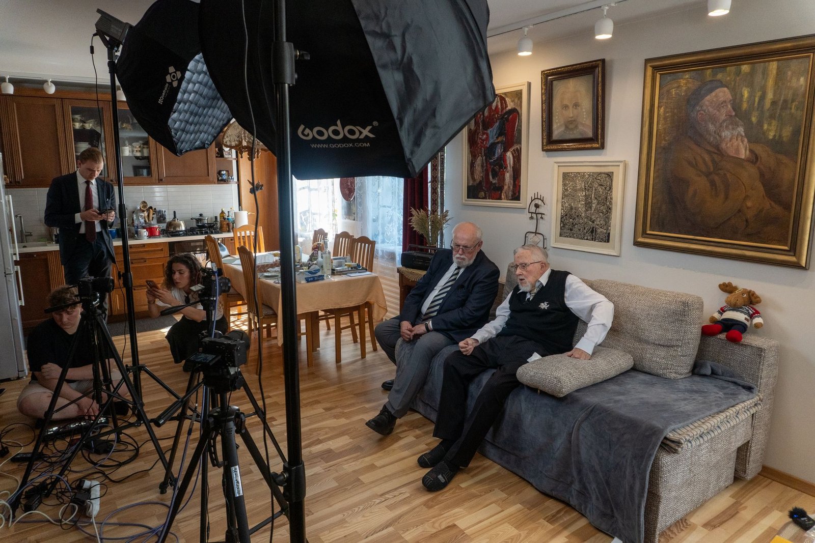 The Record in Vilnius team filming a conversation at a client's home: four cameras, lights and audio gear